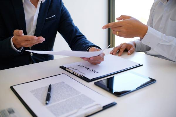two business people desk insurance
